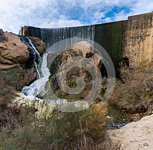View of the waterfall and overflow of the dam wall of the Elche Reservoir