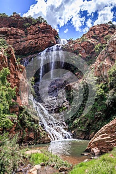 View of a waterfall and river in a mountainous area in Walter Sisulu National botanical gardens