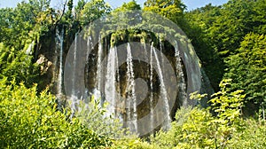 View of waterfall and rock, beautiful nature landscape, Plitvice Lakes in Croatia, National Park, sunny day with blue sky