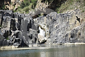 View of waterfall of water between the stones photo