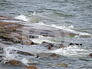 View of waves on rocky coast of Baltic sea on the island of Sveaborg in Finland