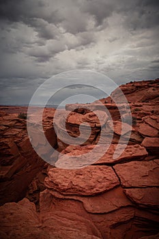 View of Wavy Stones Made with Red Rock, storm clouds in the sky