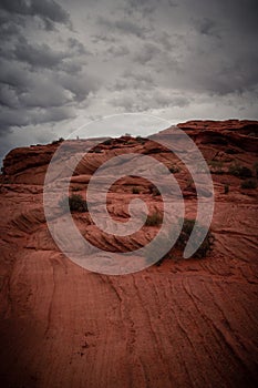 View of Wavy Stones Made with Red Rock, storm clouds in the sky