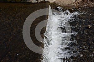 View of a weir with a lack of water for water sports. hydrological drought has ended navigability and rafting or weir is a barrier