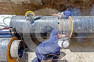 View on welding team of welders until them assembly a new pipeline