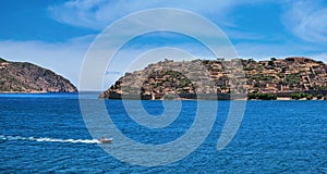 View of west bank of Spinalonga island and Venetian fortress on clear sunny summer day, Crete, Greece