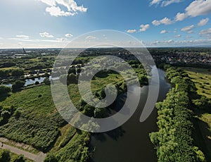 View of West Point, meadows, hairpin meander in River Mersey surrounded by plants, shrubs and trees