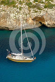 View on white boat on the beach Cala en Porter, Menorca