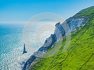 View of the white chalk headland cliffs and Beachy Head Lighthouse in the Seven Sisters National park, Eastbourne, England.