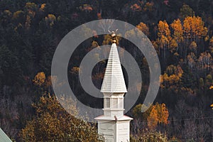 View of the white chapel, steeple in Dog Mountain, St. Johnsbury, VT, foliage, during autumn
