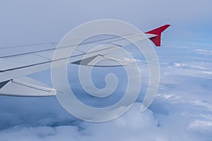View of the white clouds and Earth from the airplane porthole.