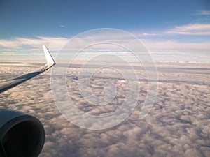 View of white clouds and plane enginie and wing