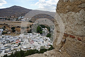 View of the white houses of the 16th-18th centuries from the ancient Acropolis of Lindos in August.