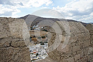 View of the white houses of the 16th-18th centuries from the ancient Acropolis of Lindos in August.