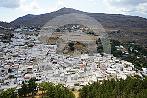 View of the white houses of the 16th-18th centuries from the ancient Acropolis of Lindos in August. Rhodes, Dodecanese, Greece.