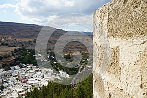 View of the white houses of the 16th-18th centuries from the ancient Acropolis of Lindos in August. Rhodes, Dodecanese, Greece.