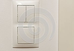 View of white light switch pair on wall . Building construction elements concept. Interior.