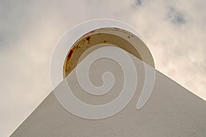 A view of a white lighthouse of Cabo Ortegal (CariÃ±o) in the Galician coast bathed by the Atlantic Ocean, a cloudy sky photo