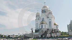 View of white orthodox church on hill in Ekaterinburg from bottom with cloudy sky on background. Temple on blood. Church