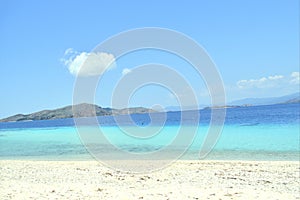 view of the white sand beach and clear blue sea water on le pirate island