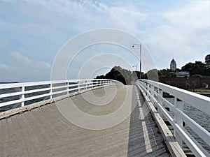 View of white wooden bridge across Baltic sea on the island Sveaborg in Finland