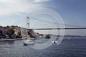 View of a white yacht, small boats, FSM bridge