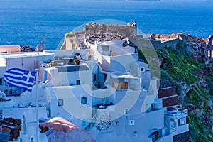 View of whitewashed buildings and Byzantine castle ruins in Oia