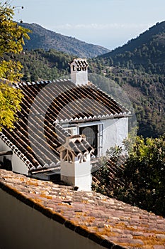 View of whitewashed houses on a mountainside in the village of Frigiliana in southern Spain photo