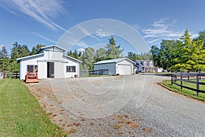 View of wide driveway to detached garages.