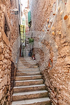 View of wide pedestrian street with coarse stone pavement