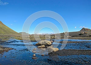 View on the wide river running from Myrdalsjokull glacier surrounded by scenic landscape, Laugavegur Trail, highlands of Iceland