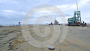 View Of A Wide Sandy Beach With Several Tower Mining Units