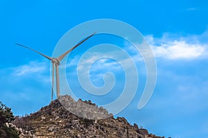 View of a wind turbine on top of mountains