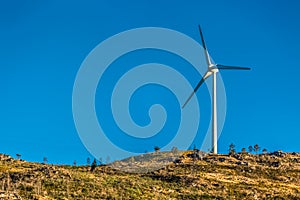 View of a wind turbine on top of mountains