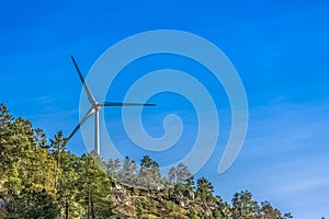 View of a wind turbine on top of mountains