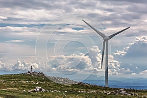 View of a wind turbine on top of mountains