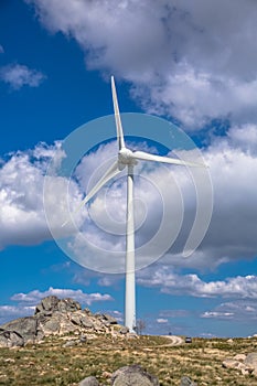 View of a wind turbine on top of mountains