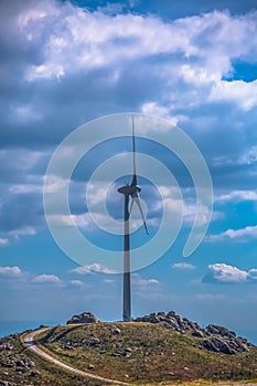 View of a wind turbine on top of mountains