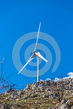 View of a wind turbine on top of mountains