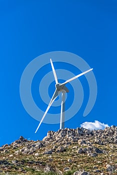 View of a wind turbine on top of mountains