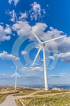 View of a wind turbine on top of mountains