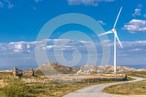 View of a wind turbine on top of mountains