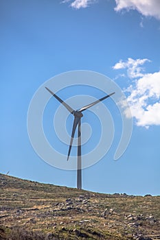 View of a wind turbine on top of mountains