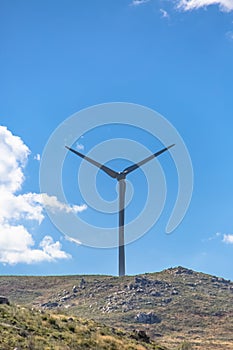 View of a wind turbine on top of mountains