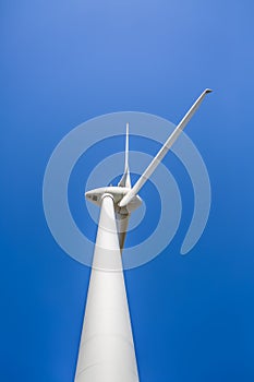 View of a wind turbine on top of mountains