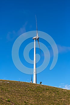 View of a wind turbine on top of mountains