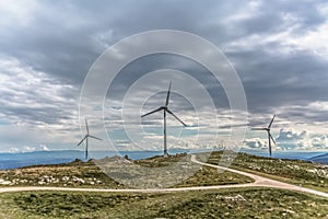 View of a wind turbines on top of mountains