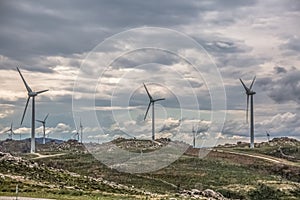 View of a wind turbines on top of mountains