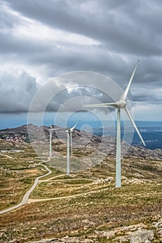 View of a wind turbines on top of mountains