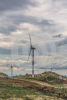 View of a wind turbines on top of mountains